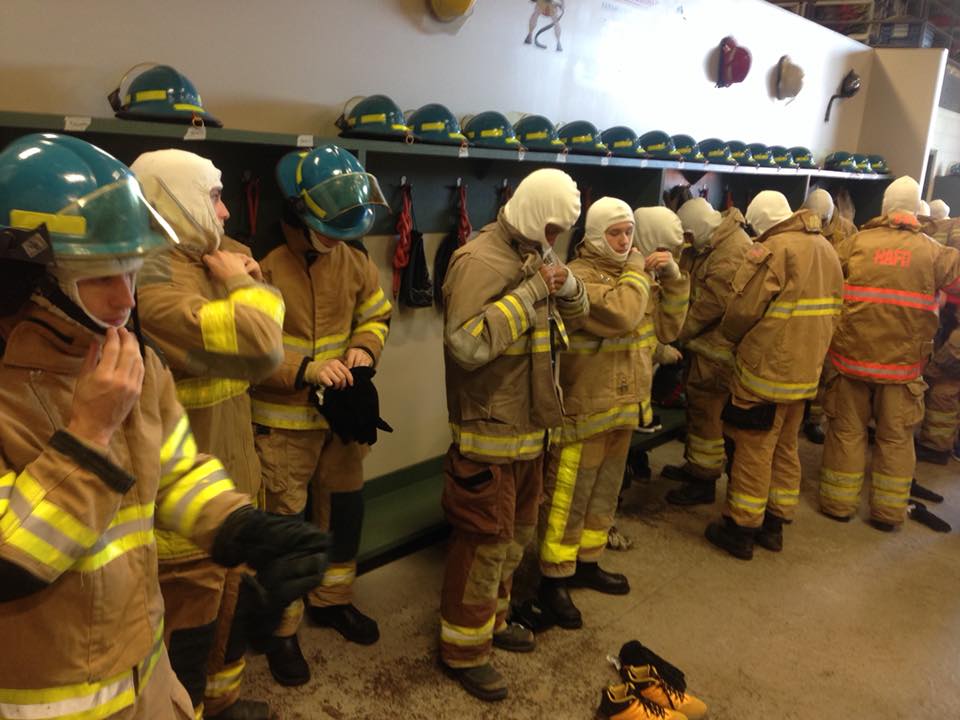 Students change into firefighting gear