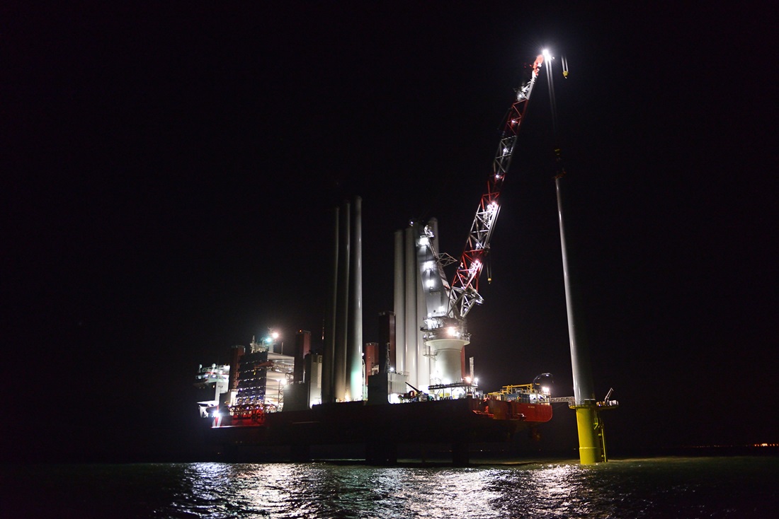 Offshore turbine being built at night