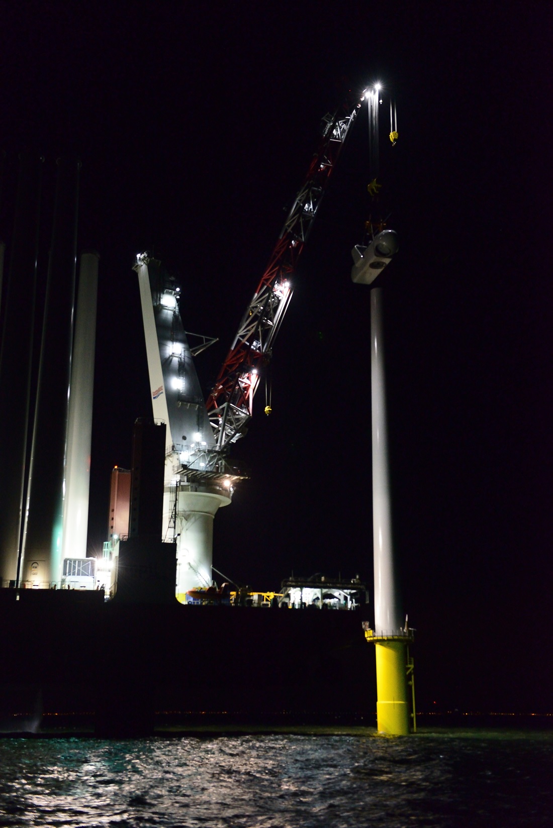 offshore turbine being built at night