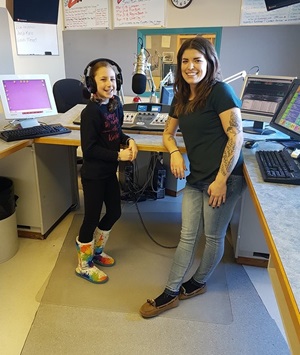 Girl on the air with DJ at radio station