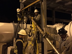 Fluid withdrawal pipe installation at night