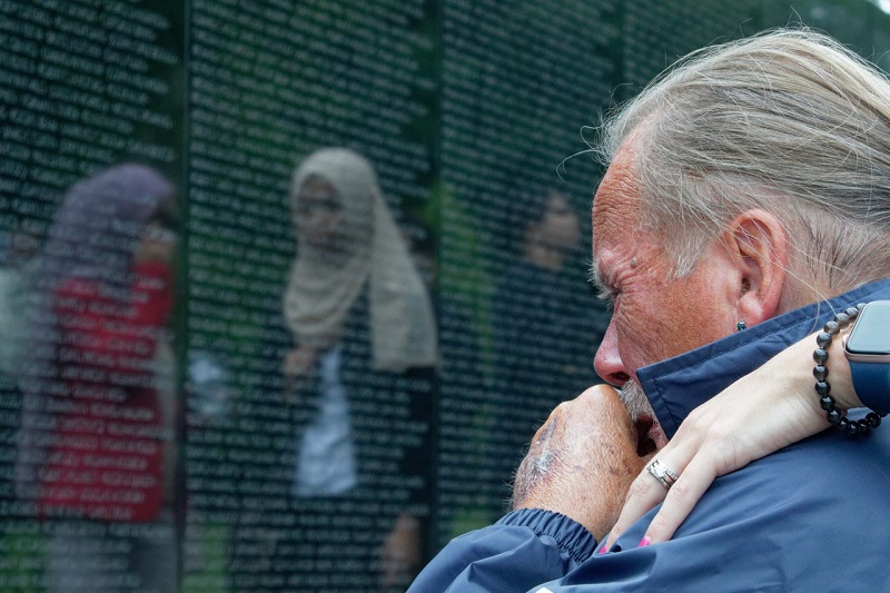 Veteran reflecting at war memorial