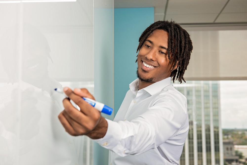 Young man writing on a whiteboard