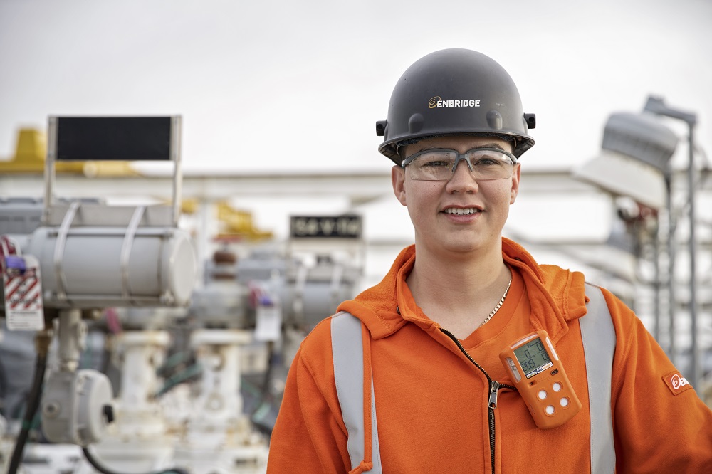 Young worker in orange overalls