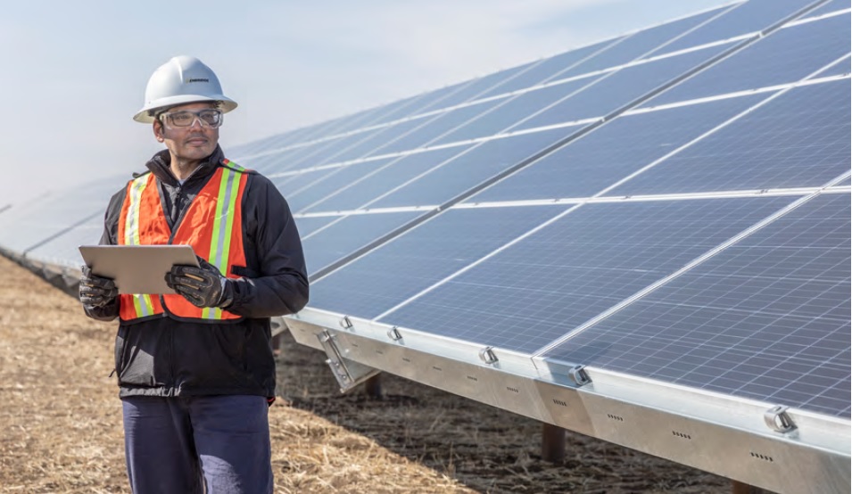 Worker in front of solar panels