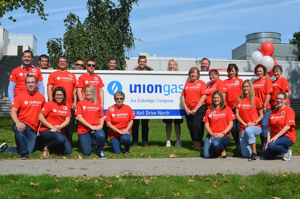 Union Gas employees in front of banner