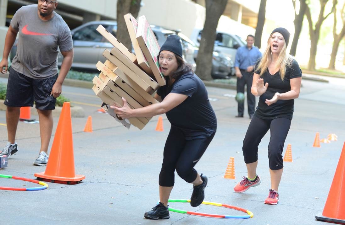 Woman running with pizza boxes