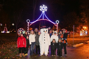 People and Frosty mascot at Christmas lights festival