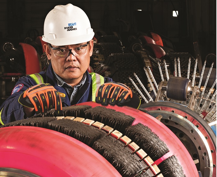 Worker examining pipeline inspection tool