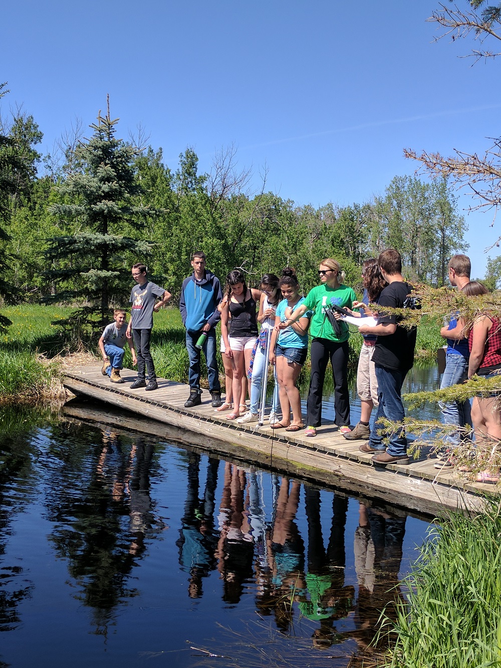 High school students at a pond
