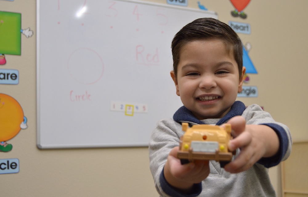 Small child holding a toy