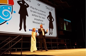 People on stage at large gathering