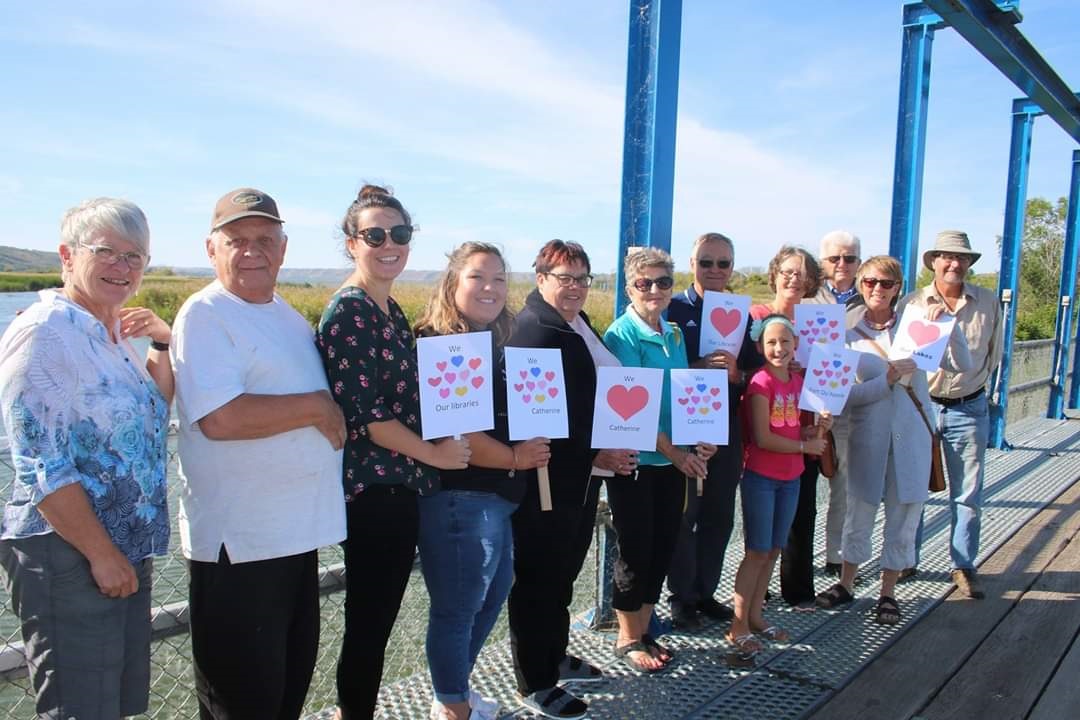 Several people holding up signs