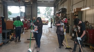 Kids cleaning up a warehouse