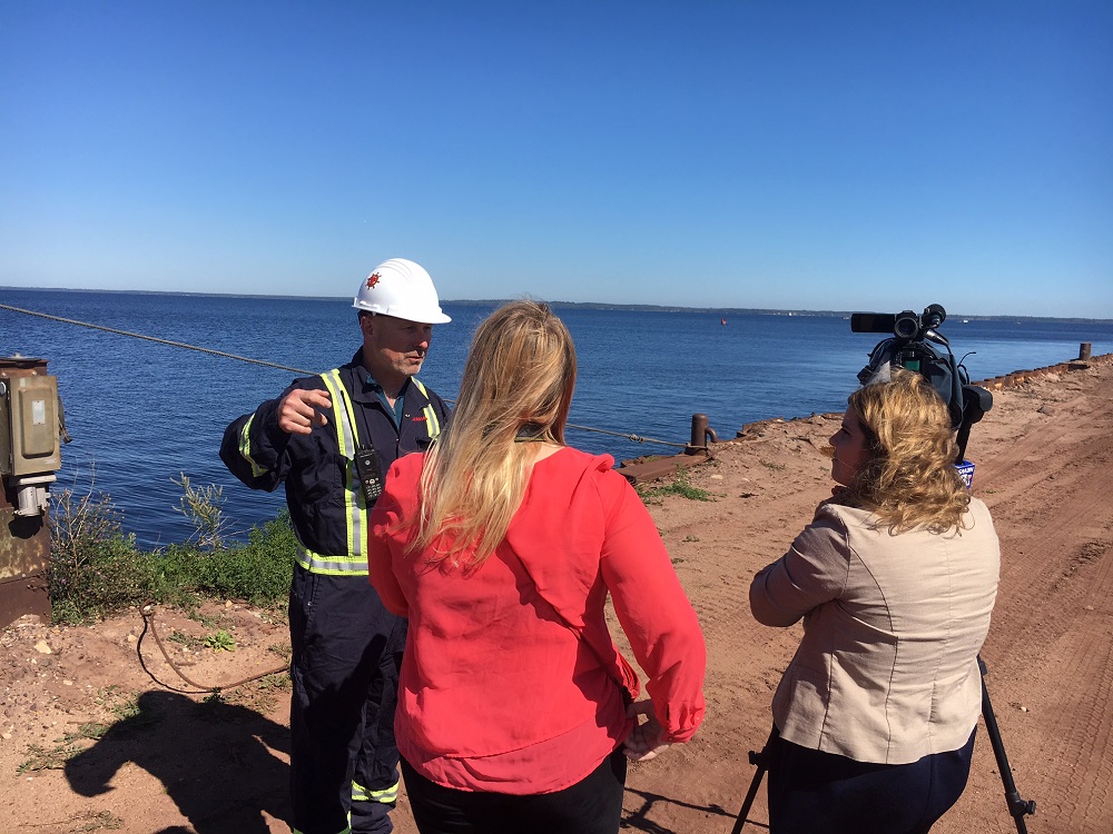 Enbridge worker with TV camera crew