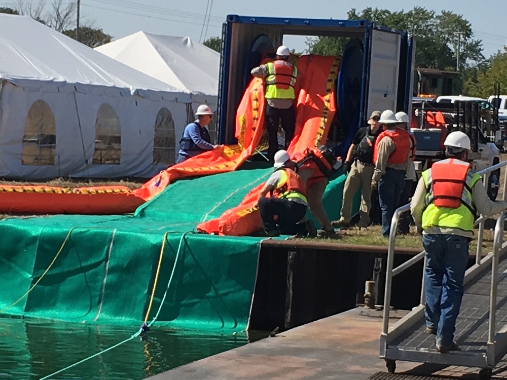Response workers deploying containment boom
