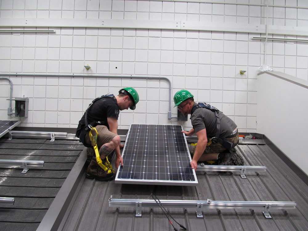 Students fix a solar panel