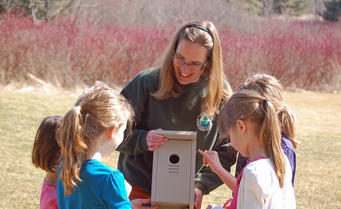 Woman and girls with birdbox