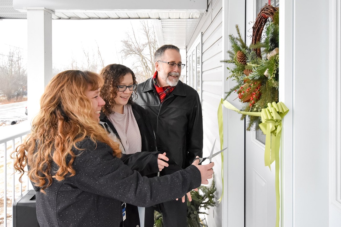 People at a front door of a house