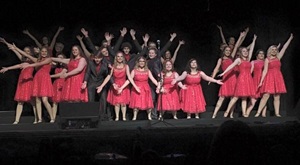 Girls in theatre group wearing red dresses