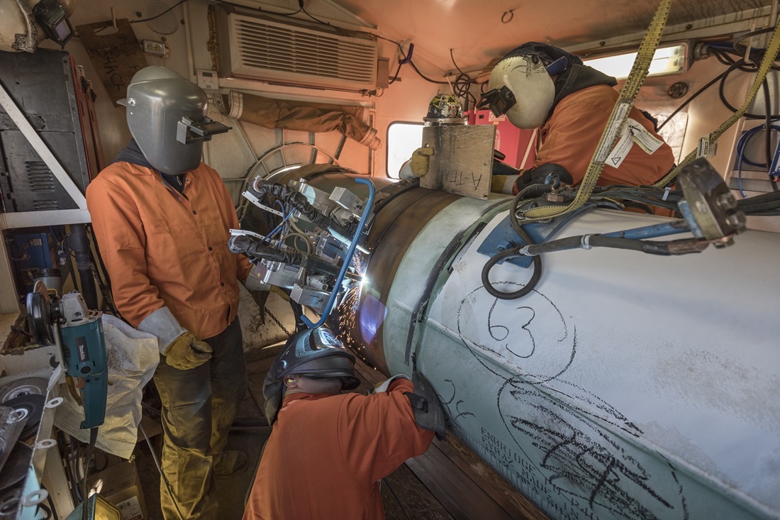 Pipeline welders in welding shack