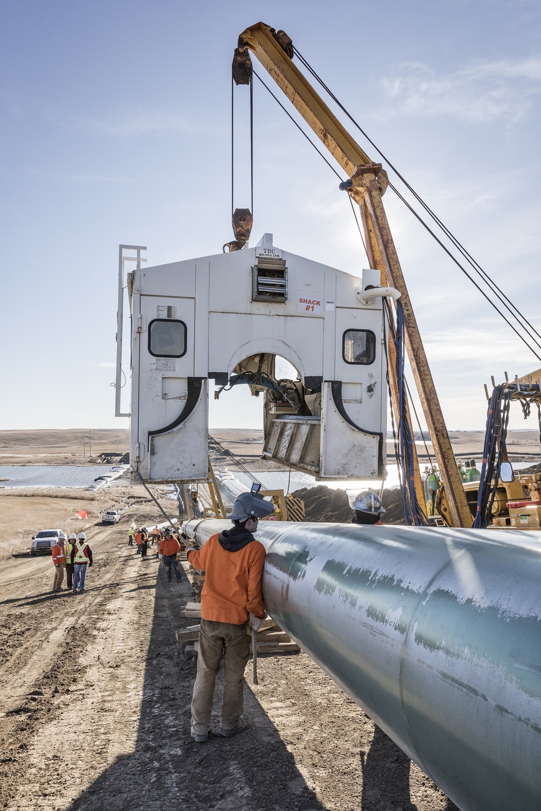 Welding shack being lowered on to pipeline