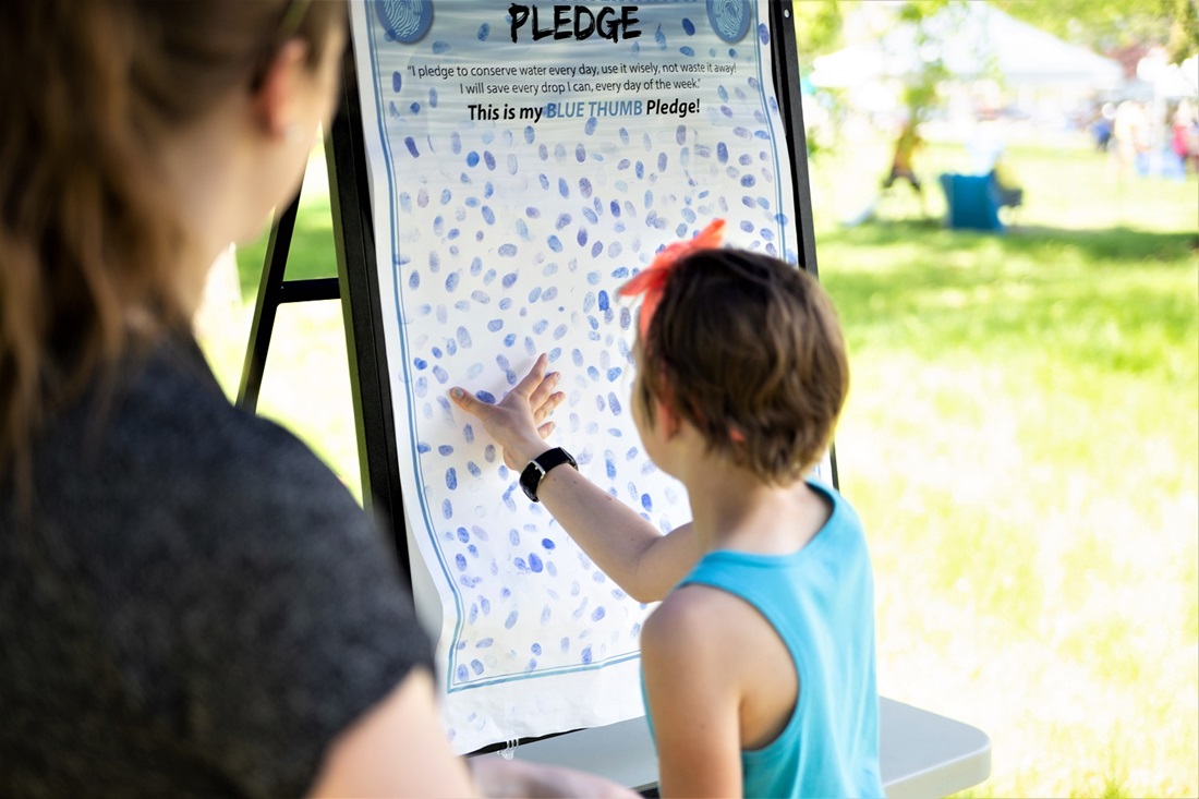 Child signing pledge board