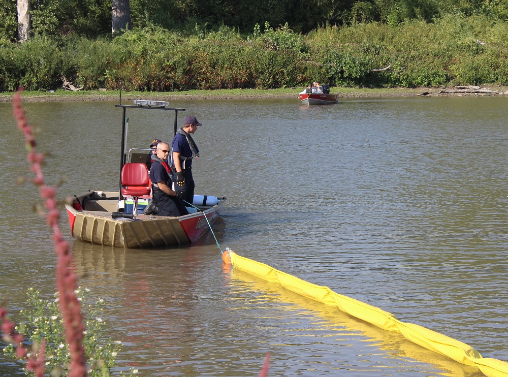 workers deploying equipment on a river