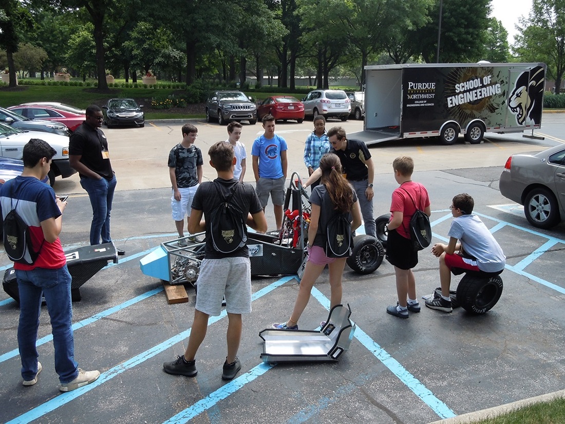 engineering summer camp students building a car