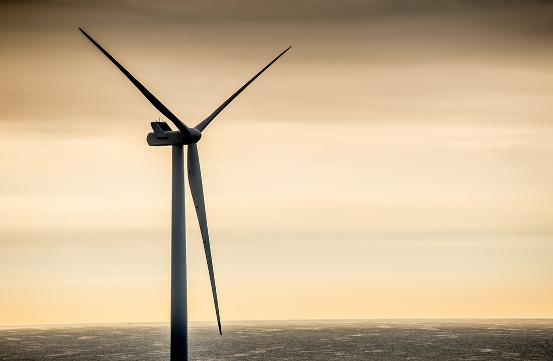 Offshore wind turbine at sunset