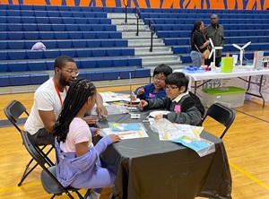 Kids at a table in a school gym