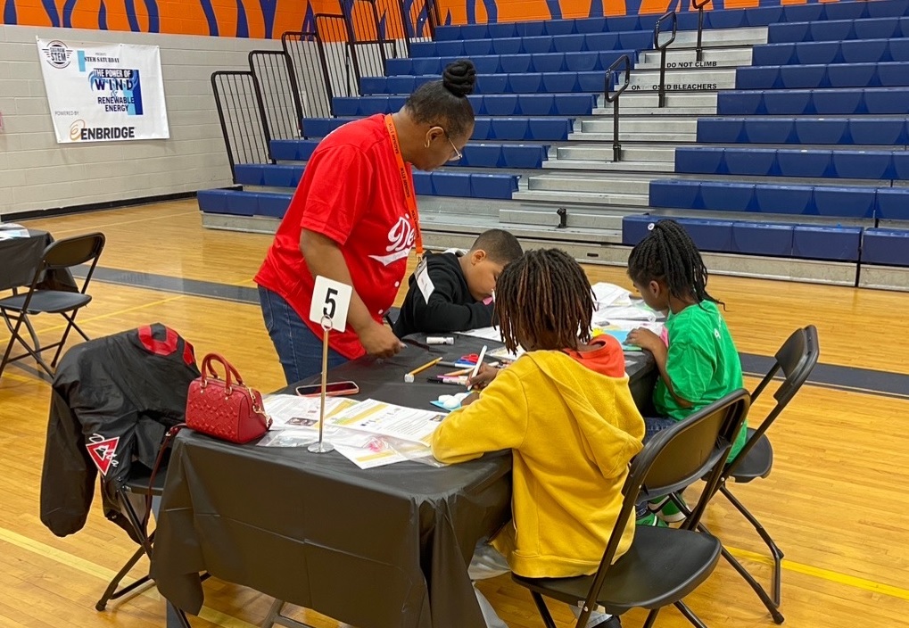 Kids at a table in a school gym