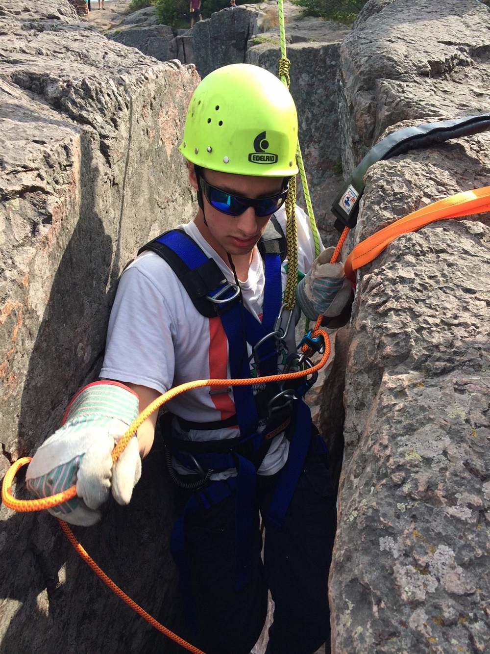 rock climber with ropes and harness