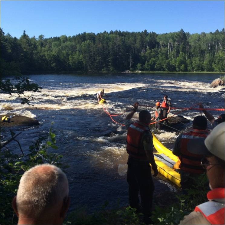 rescue volunteers at the edge of a river