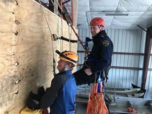 rescue volunteers on climbing wall