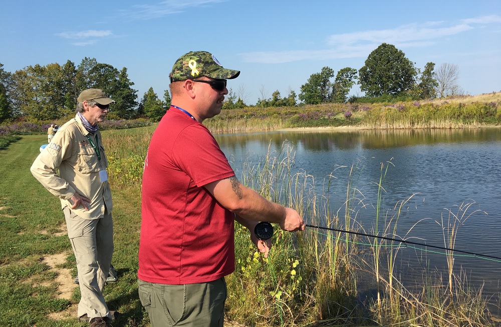 Fishing enthusiasts on a riverbank