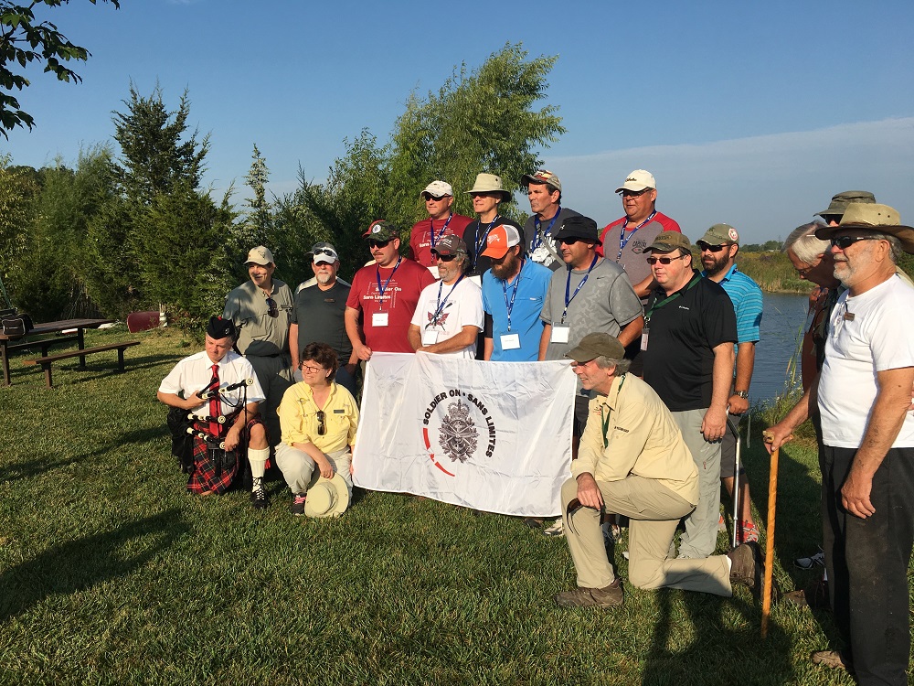Fishing enthusiasts in front of a banner