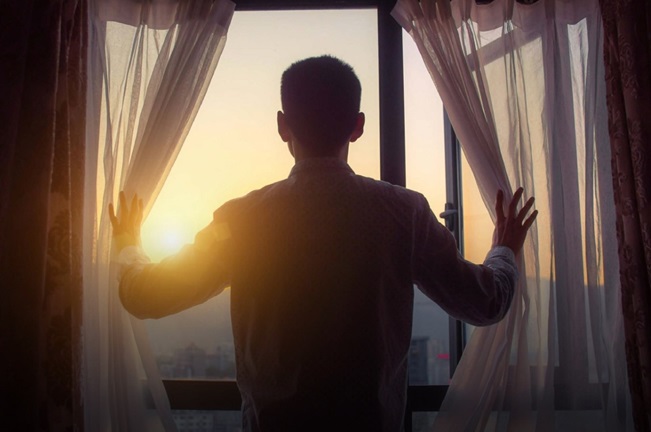Person looking at the sunrise