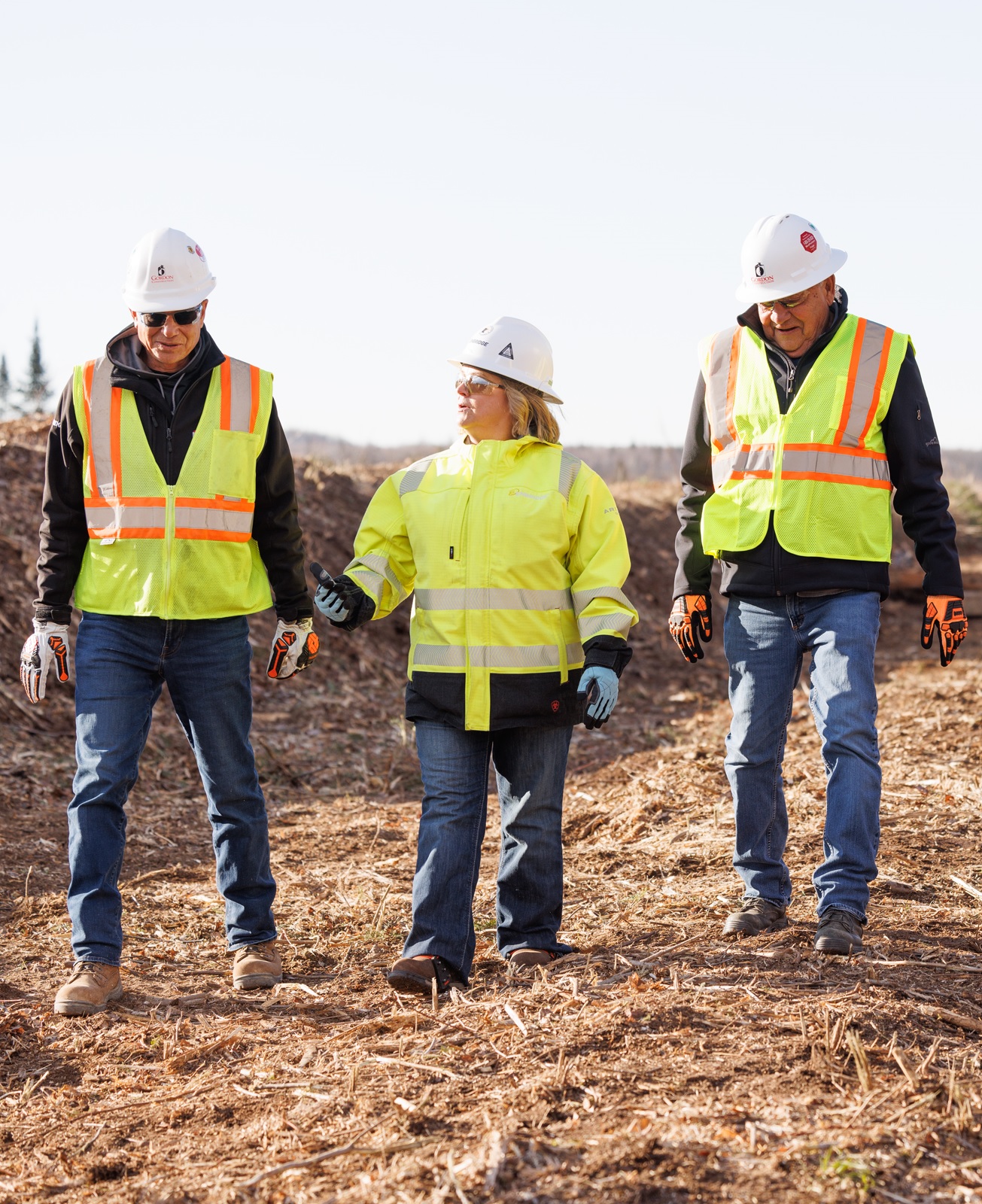 People in safety gear walking outside