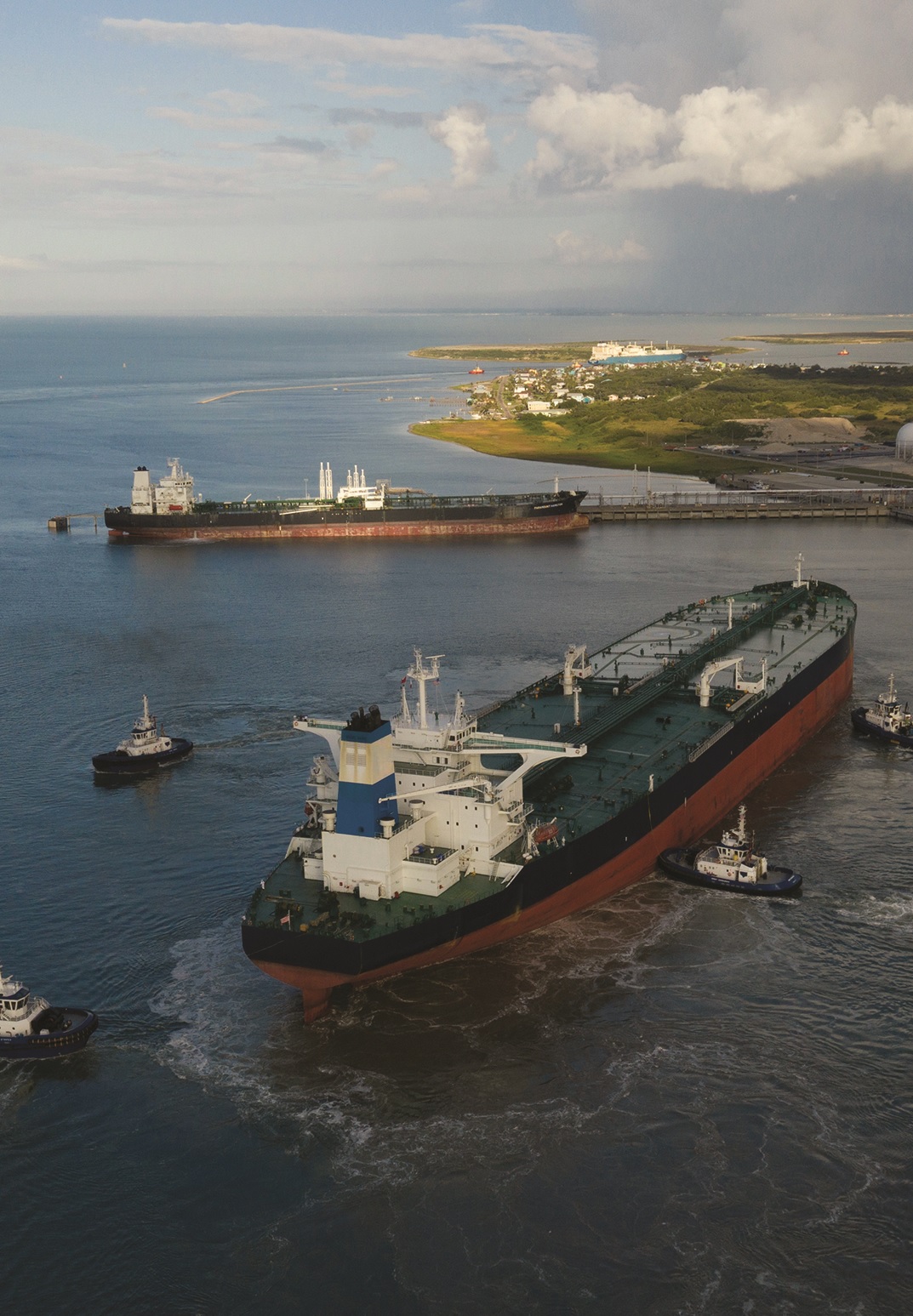 Large ship and tugboats at a port