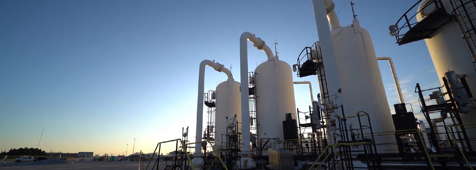 Large tanks and pipes at sunrise