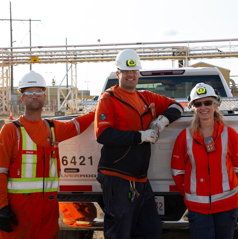 Workers leaning on a truck