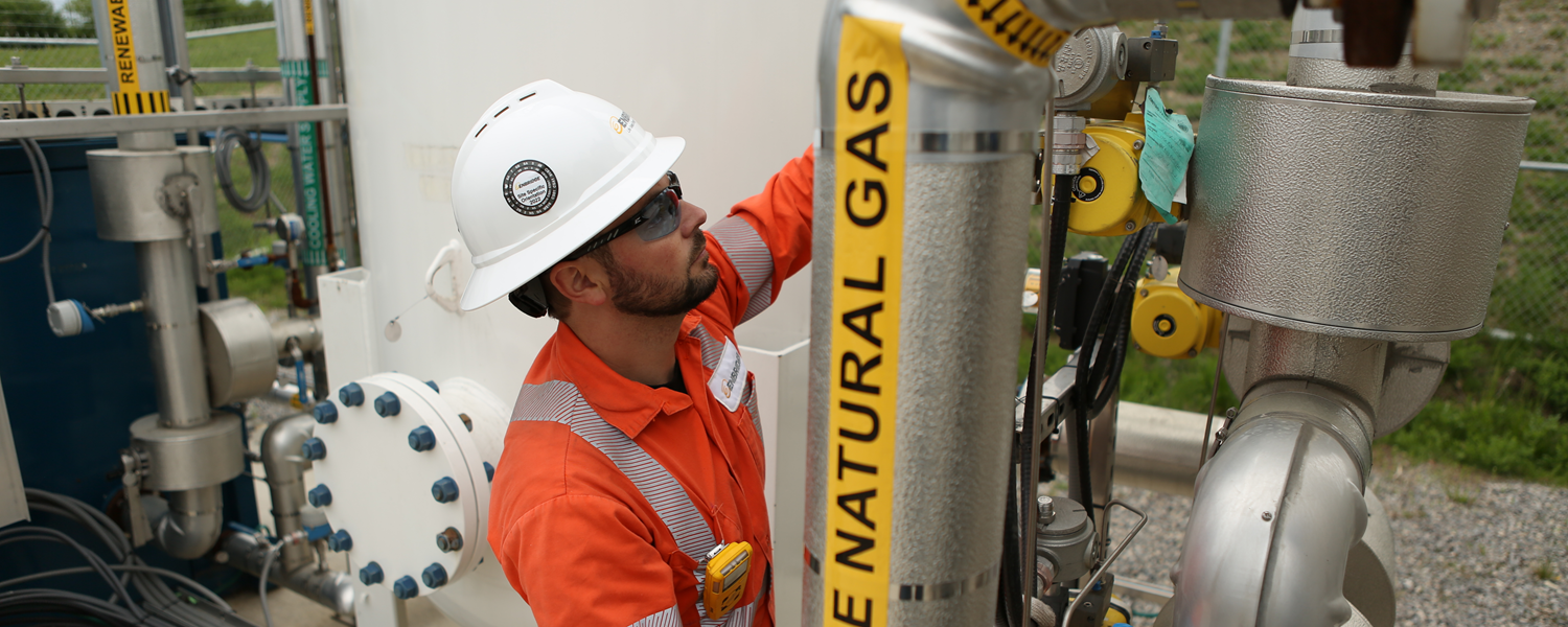 Worker examining piping