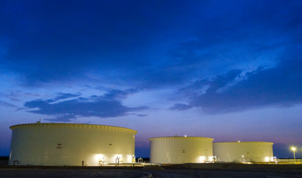 Large white tanks at dusk