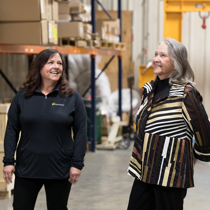 Two women walking in a warehouse