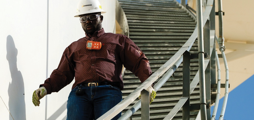 Worker walking down stairs on a tank