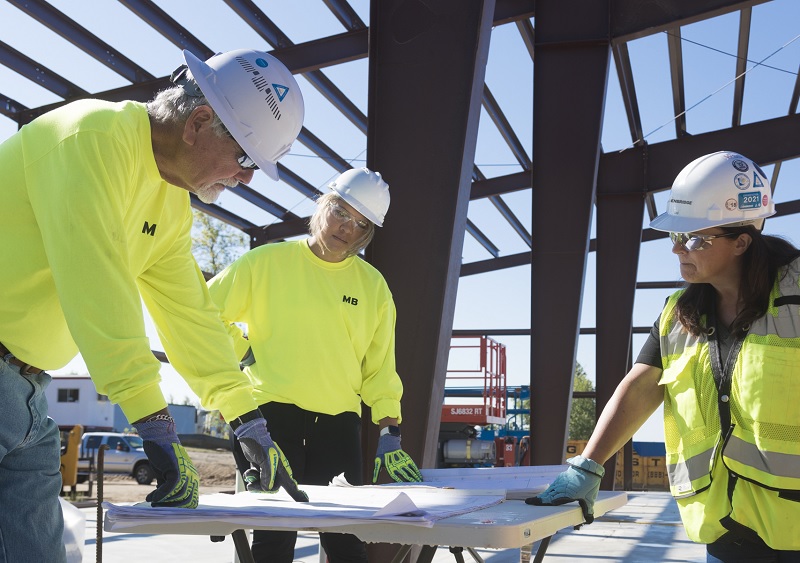 People looking at a blueprint on a table