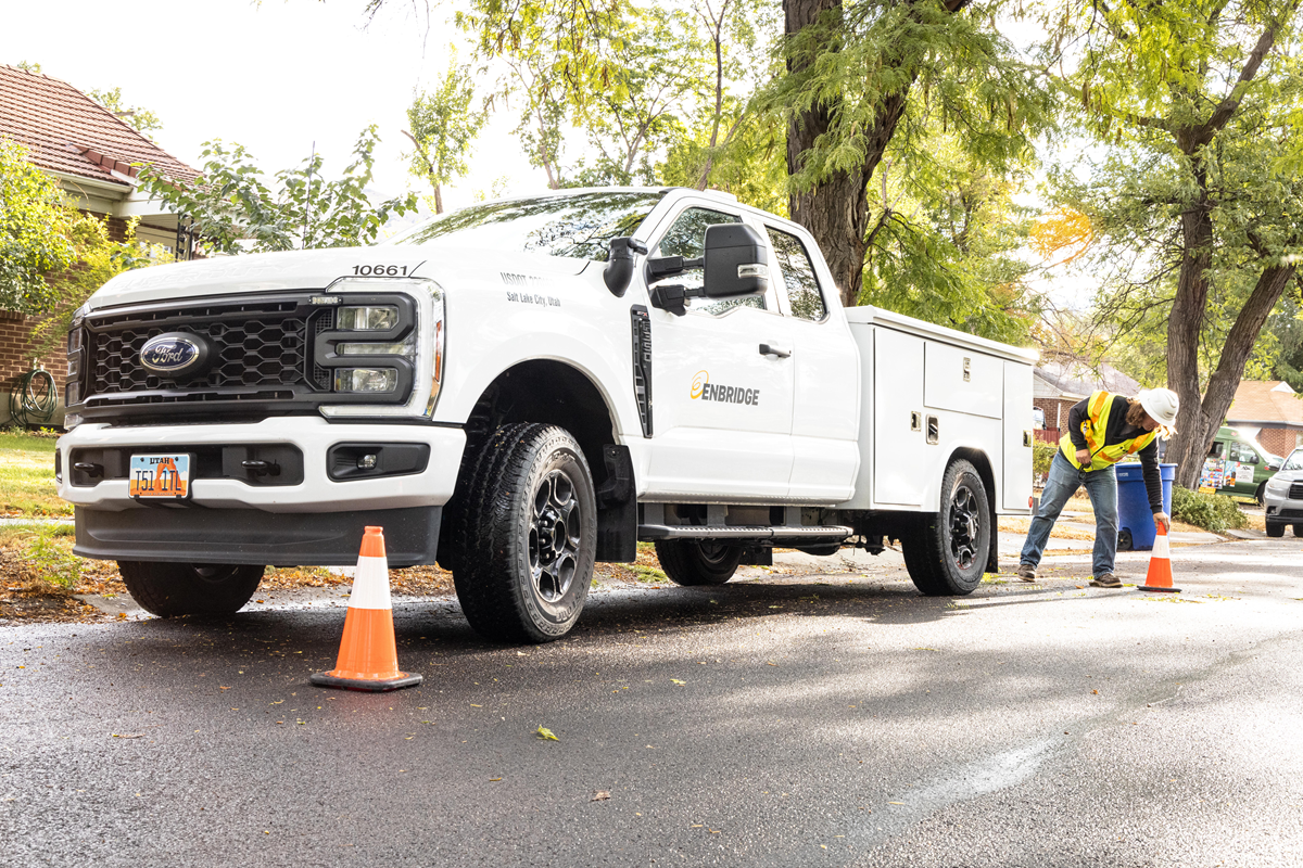 Enbridge truck and worker setting cones