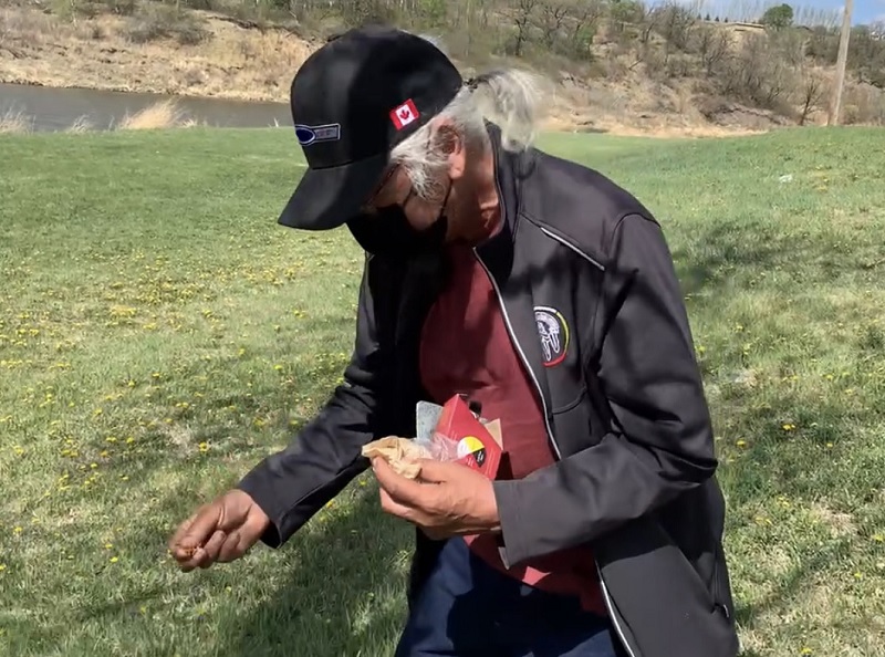 Man sprinkling something on the ground