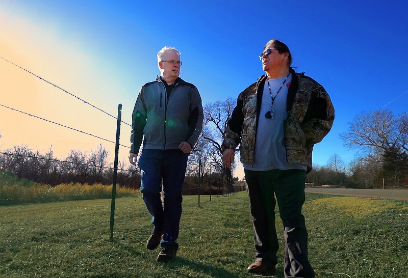 Two men walking in a field